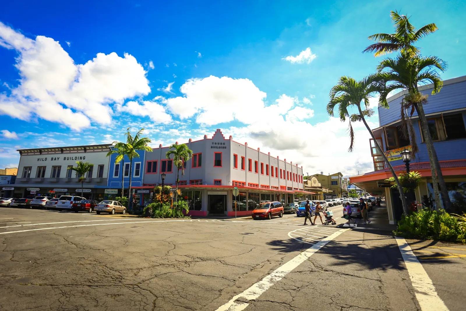 Downtown Hilo street corner with the Hilo Bay Building and palm trees