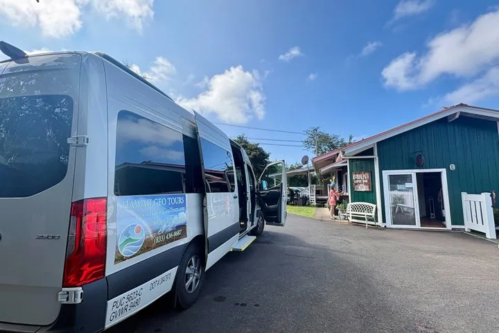 Hawaii Geo Tours van parked outside a small green coffee bar building